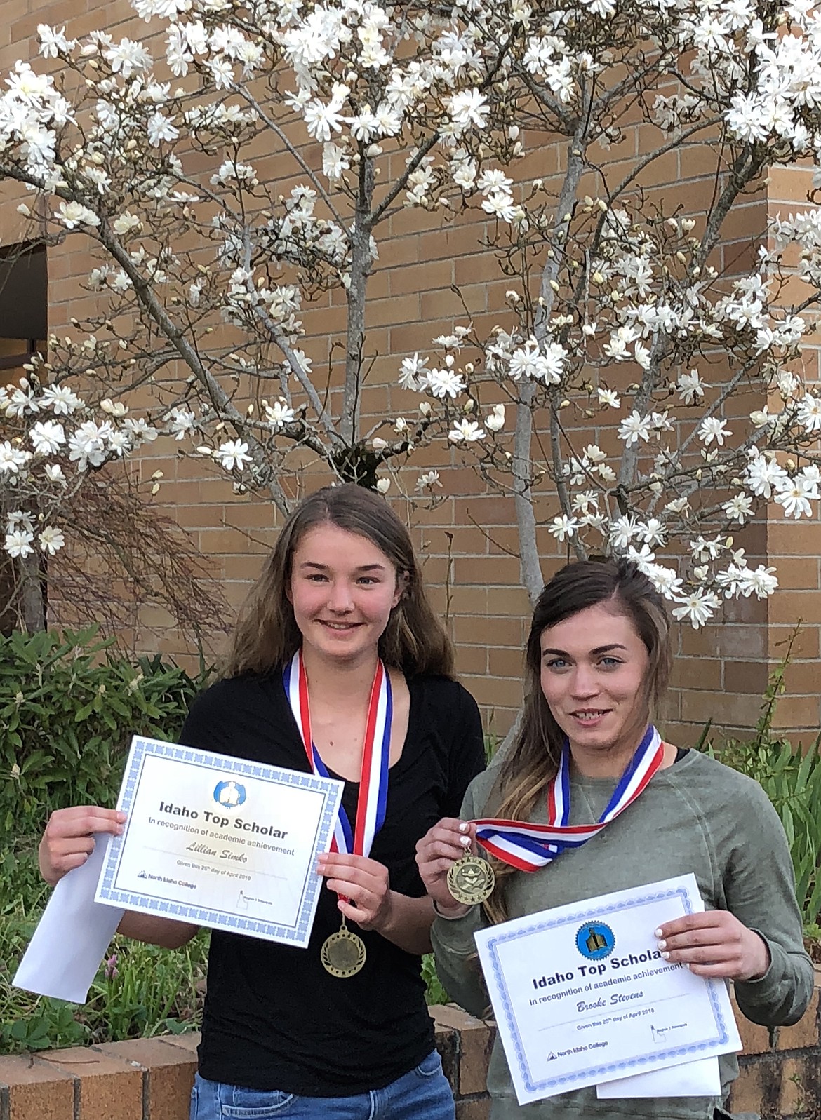 (Courtesy photo)
Clark Fork High School students Lily Simko, left, and Brooke Stevens, right, recently attended the Idaho Top Scholars program at North Idaho College.  The program recognizes the top 10 percent of the region&#146;s junior class for their academic success. The two girls walked across the stage at the NIC Schuler Performing Arts Building to accept recognition from their principal and received applause by a packed auditorium filled with parents, family, and the rest of the top 10 percent of Idaho&#146;s Region 1.