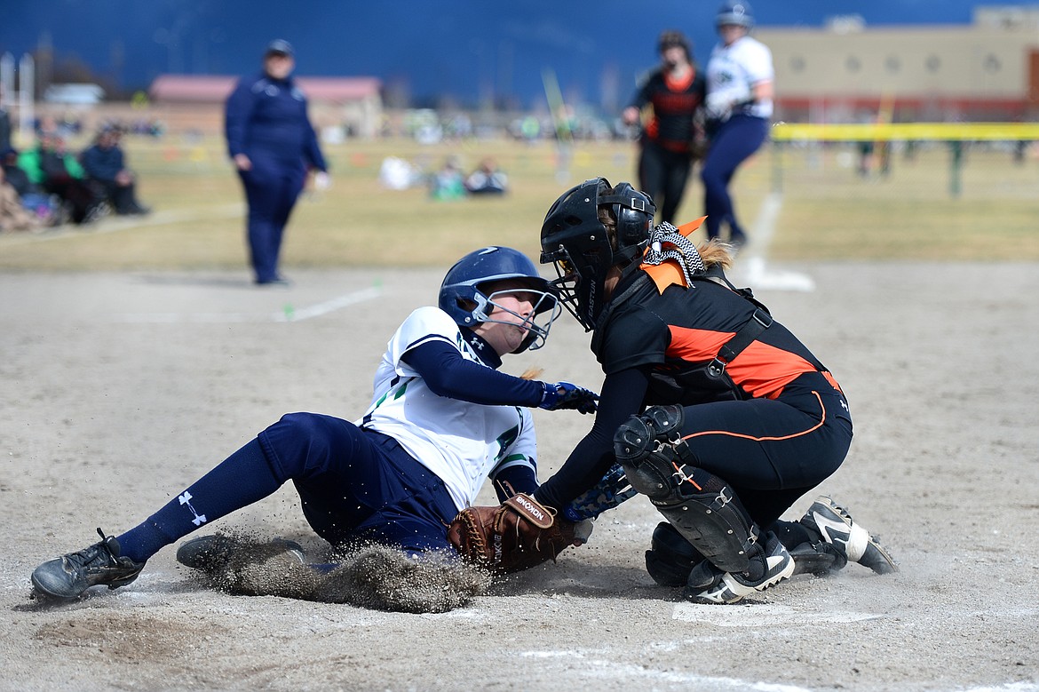 Glacier's Sophie Smith is tagged out at the plate by Flathead catcher Jayden Russell in the bottom of the 4th inning on Tuesday. (Casey Kreider/Daily Inter Lake)