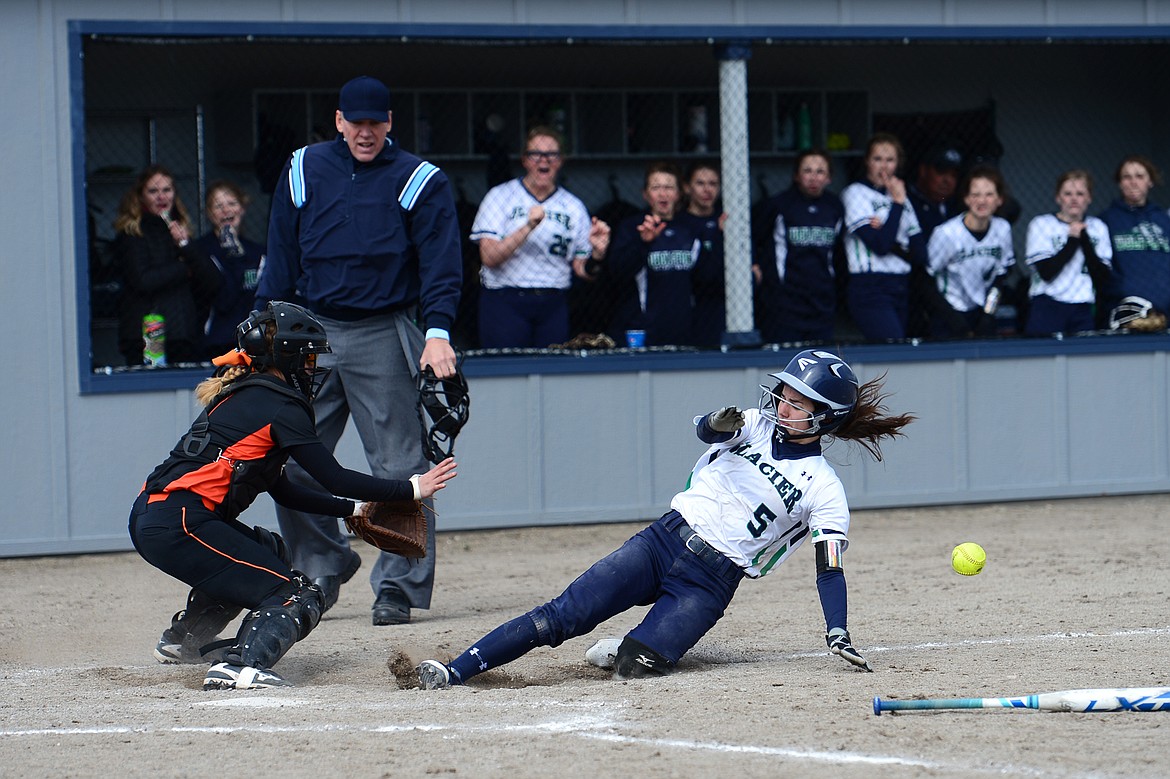 Glacier's Kenna Vanorny slides safely into home ahead of the throw in the bottom of the 6th inning against Flathead on Tuesday. (Casey Kreider/Daily Inter Lake)