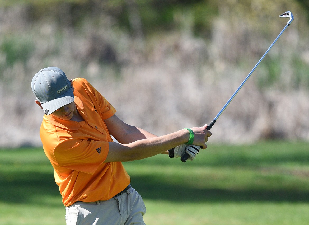 Eureka&#146;s Tristan Kaufman hits from the 15th fairway at Eagle Bend Golf Club on Tuesday. (Casey Kreider/Daily Inter Lake)