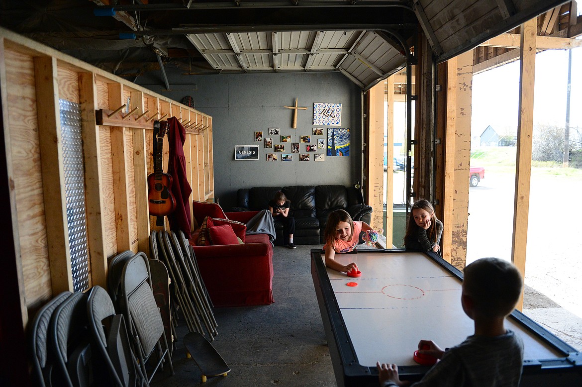 Kids play air hockey during an open skate session at Serious JuJu at 707 W. Center St. in Kalispell on Friday, May 4. (Casey Kreider/Daily Inter Lake)