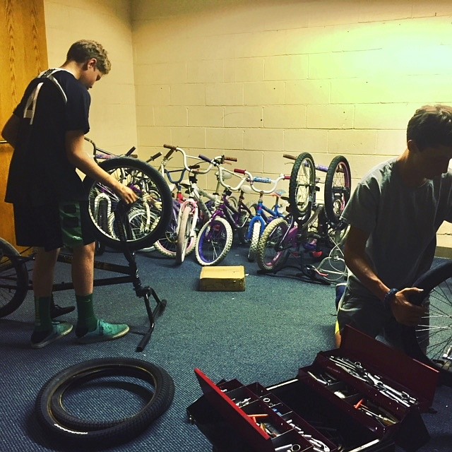 Young cyclists work on bicycles at Lake City Bicycle Collective. (TOM MORGAN/Courtesy)