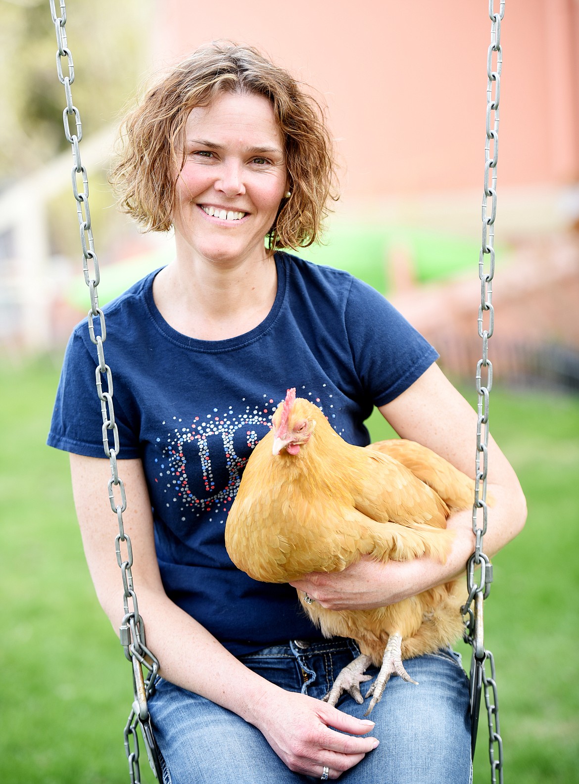 Shannon Eve with Cotton a full grown buff Orpington hen on Thursday afternoon, May 3, in Kalispell.(Brenda Ahearn/Daily Inter Lake)