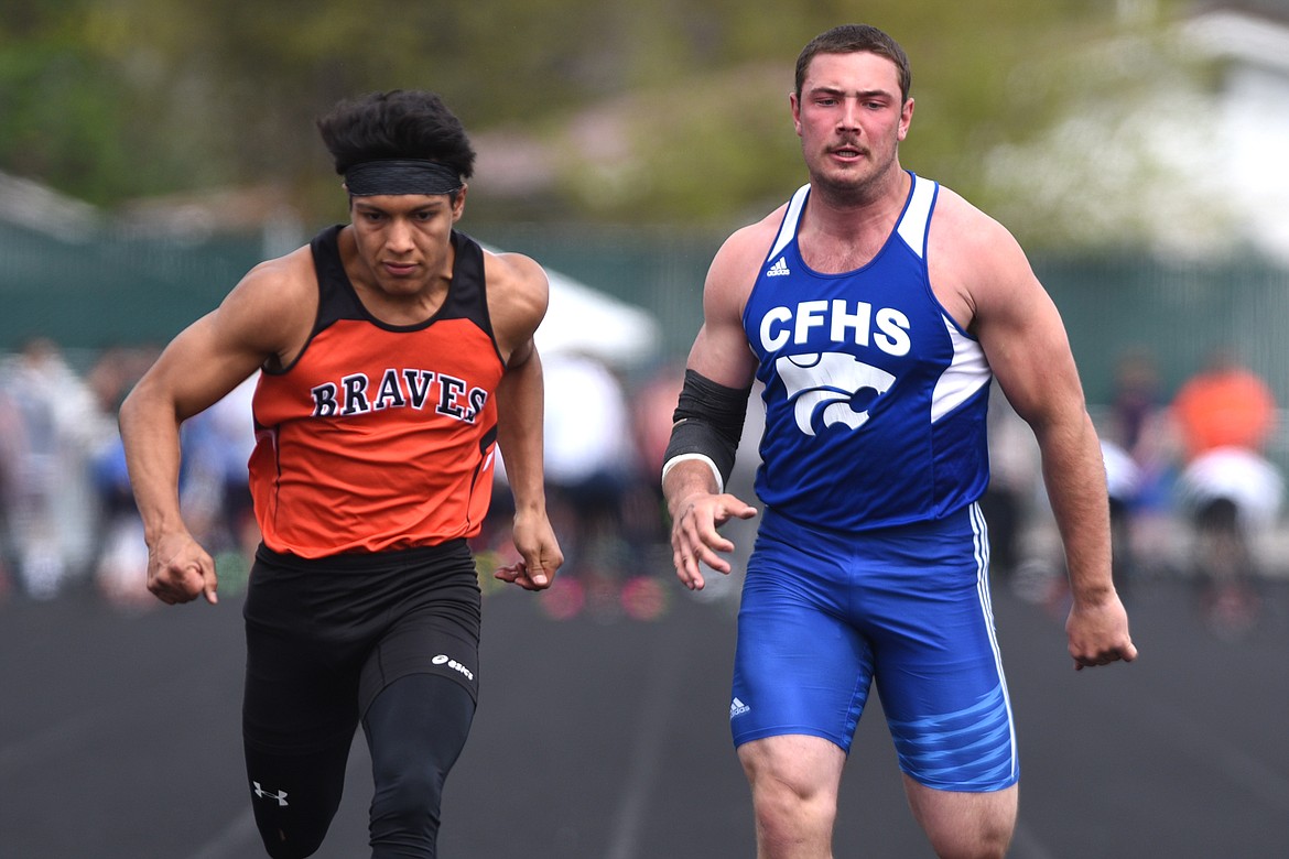 Flathead's Trae Vasquez, left, and Columbia Falls' Logan Kolodejchuk compete in the boys 100-meter dash at the Archie Roe track and field meet at Legends Stadium on Saturday. (Casey Kreider/Daily Inter Lake)