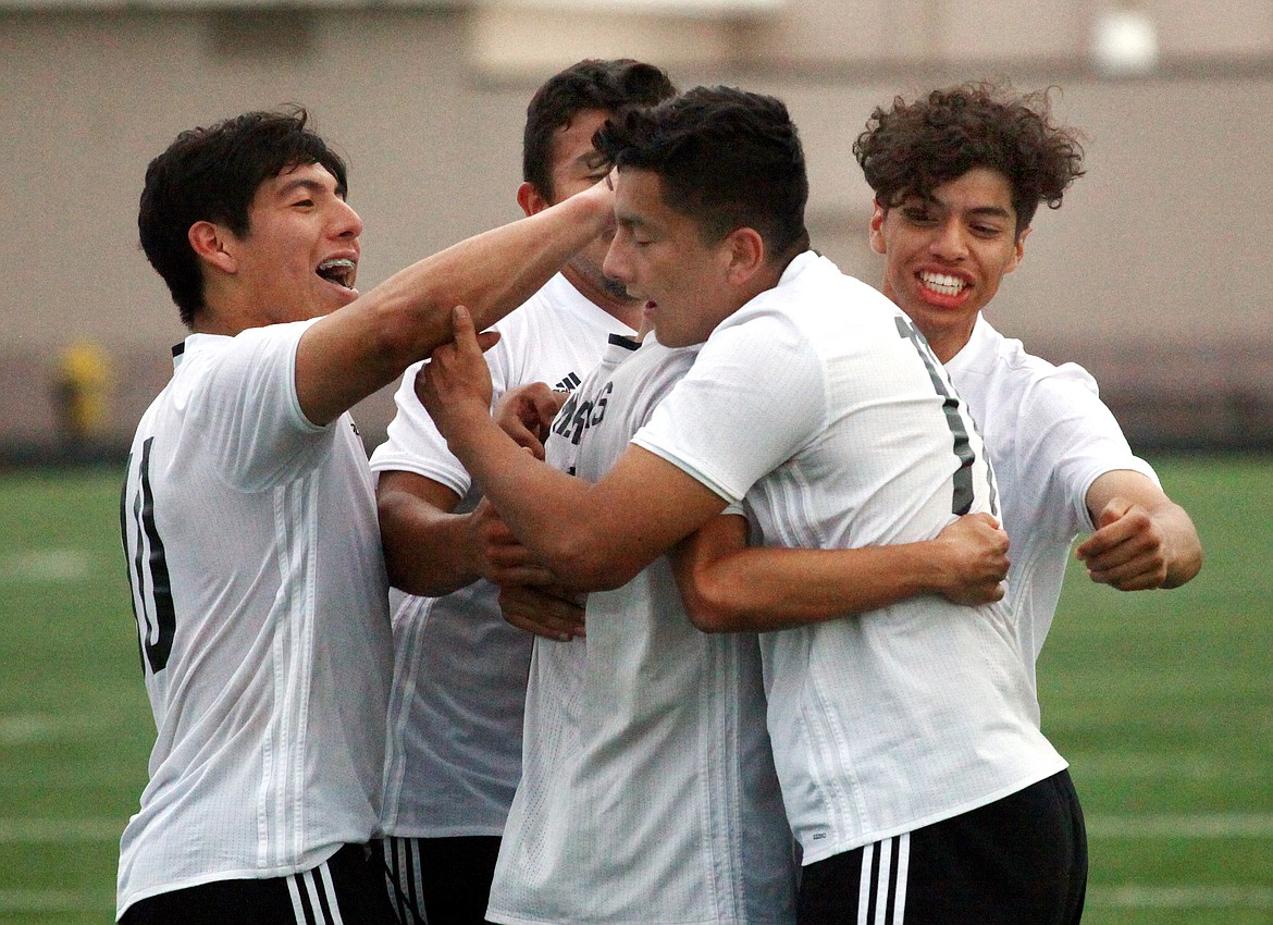 Rodney Harwood/Columbia Basin Herald
Royal players congratulate senior Michael Rojas after scoring on a penalty kick in the 67th minute of Tuesday's 1A district semifinal game at David Nielsen Memorial Stadium. The shot proved to be the game-winner and the Knights advanced.