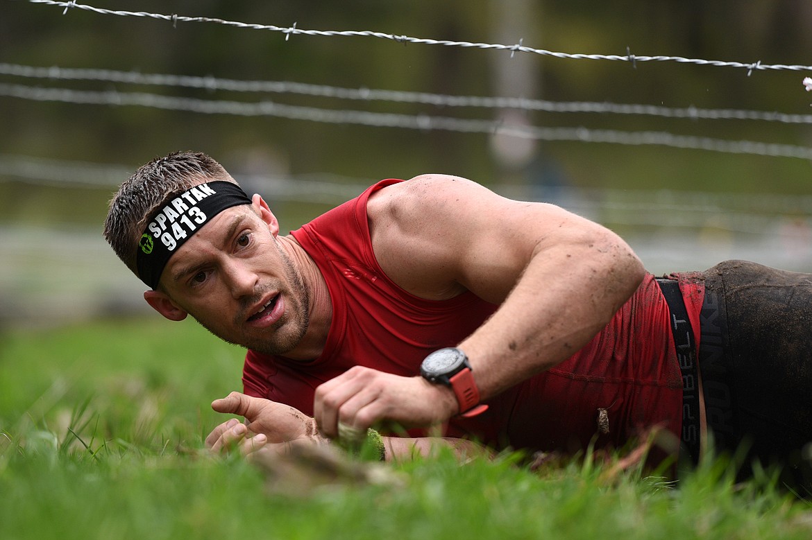 Competitors navigate a barbed wire section of the 13-mile &#147;Beast&#148; course at Spartan&#146;s Mountain Series Race in Bigfork on Saturday. (Casey Kreider/Daily Inter Lake)