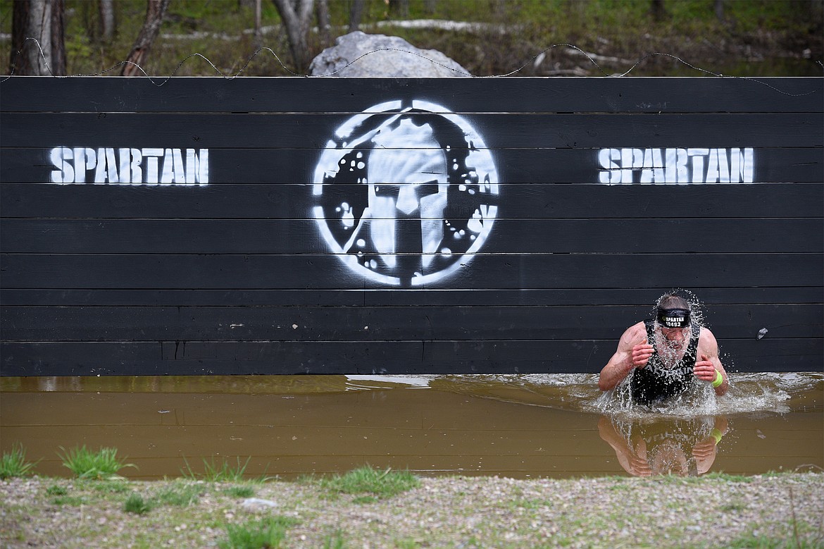 A competitor splashes through a section of the 13-mile &#147;Beast&#148; course.
 (Casey Kreider/Daily Inter Lake)