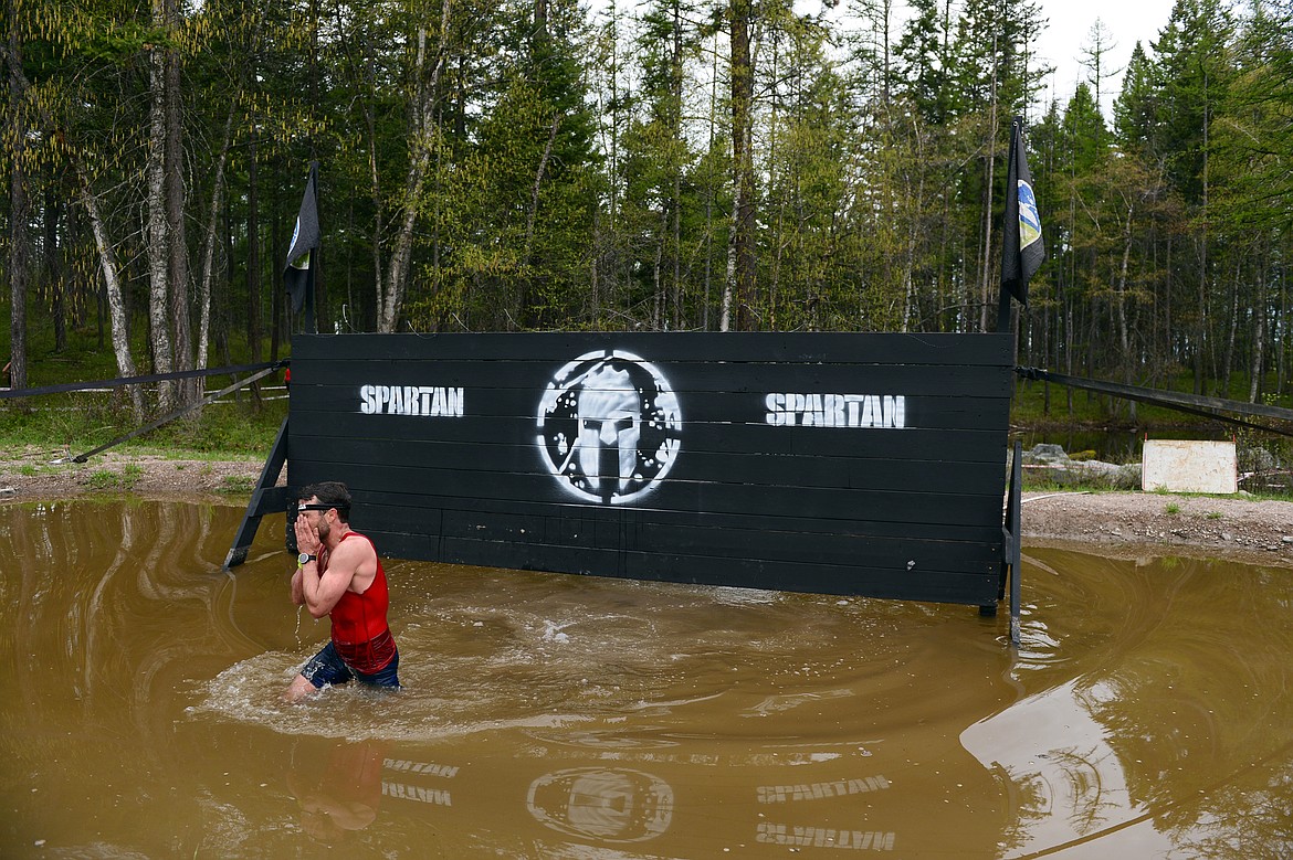 A competitor emerges from a water obstacle during  the 13-mile &#147;Beast&#148; course at Spartan&#146;s Mountain Series Race in Bigfork on Saturday. (Casey Kreider/Daily Inter Lake)