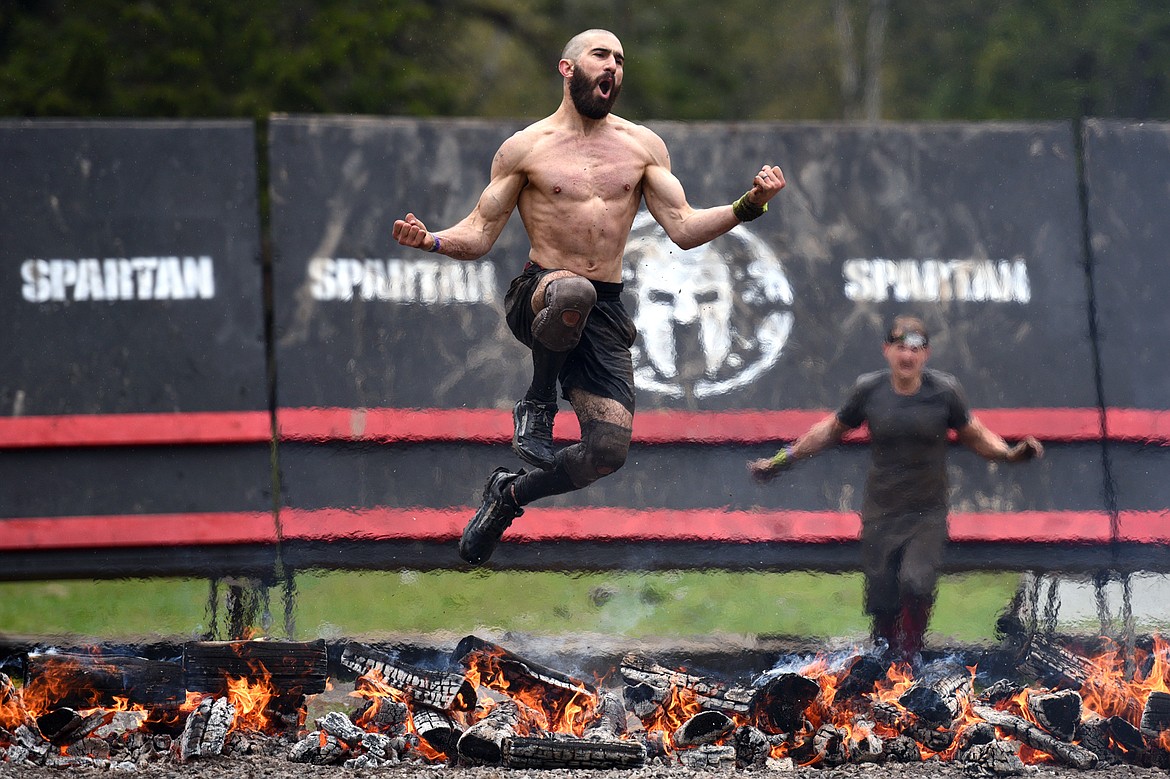 Patrick Hutchins, of Bozeman, crosses the finish line after completing the 13-mile &#147;Beast&#148; course. 
(Casey Kreider/Daily Inter Lake)