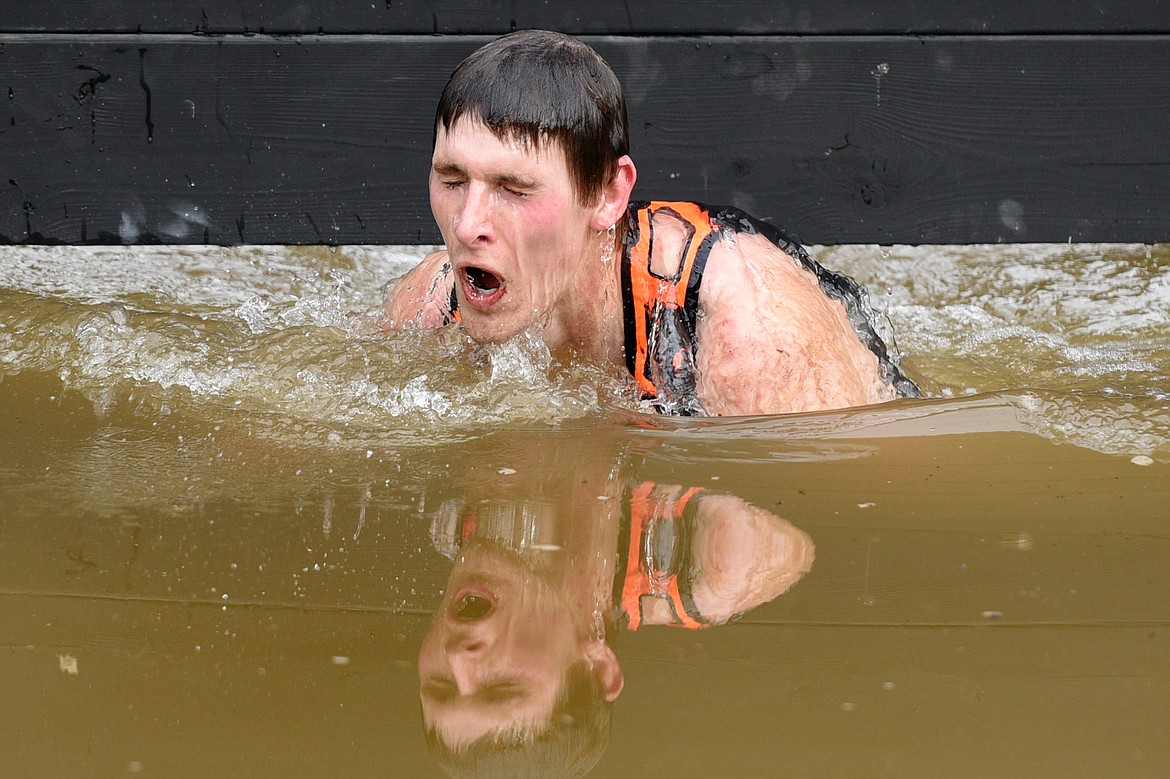 A competitor emerges from a water obstacle during  the 13-mile &#147;Beast&#148; course at Spartan&#146;s Mountain Series Race in Bigfork on Saturday. (Casey Kreider/Daily Inter Lake)