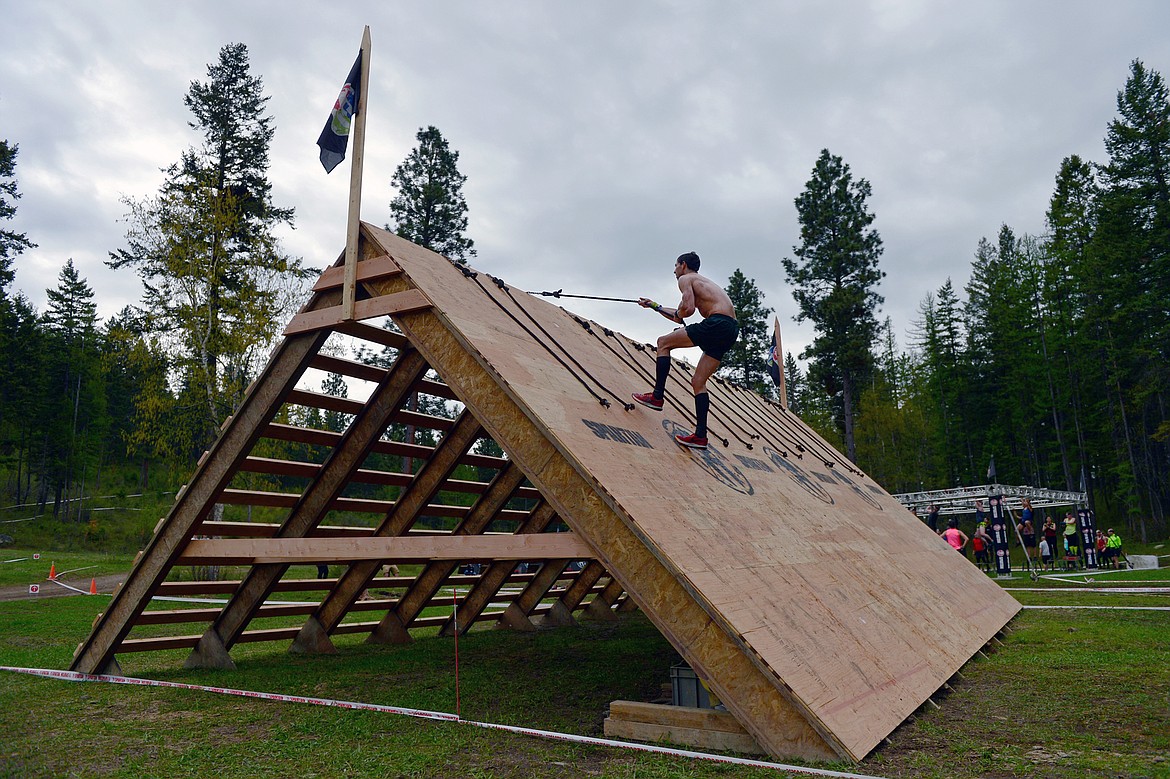 Participants scale one of the obstacles in the 13-mile Spartan Race in Bigfork.
 (Casey Kreider/Daily Inter Lake)