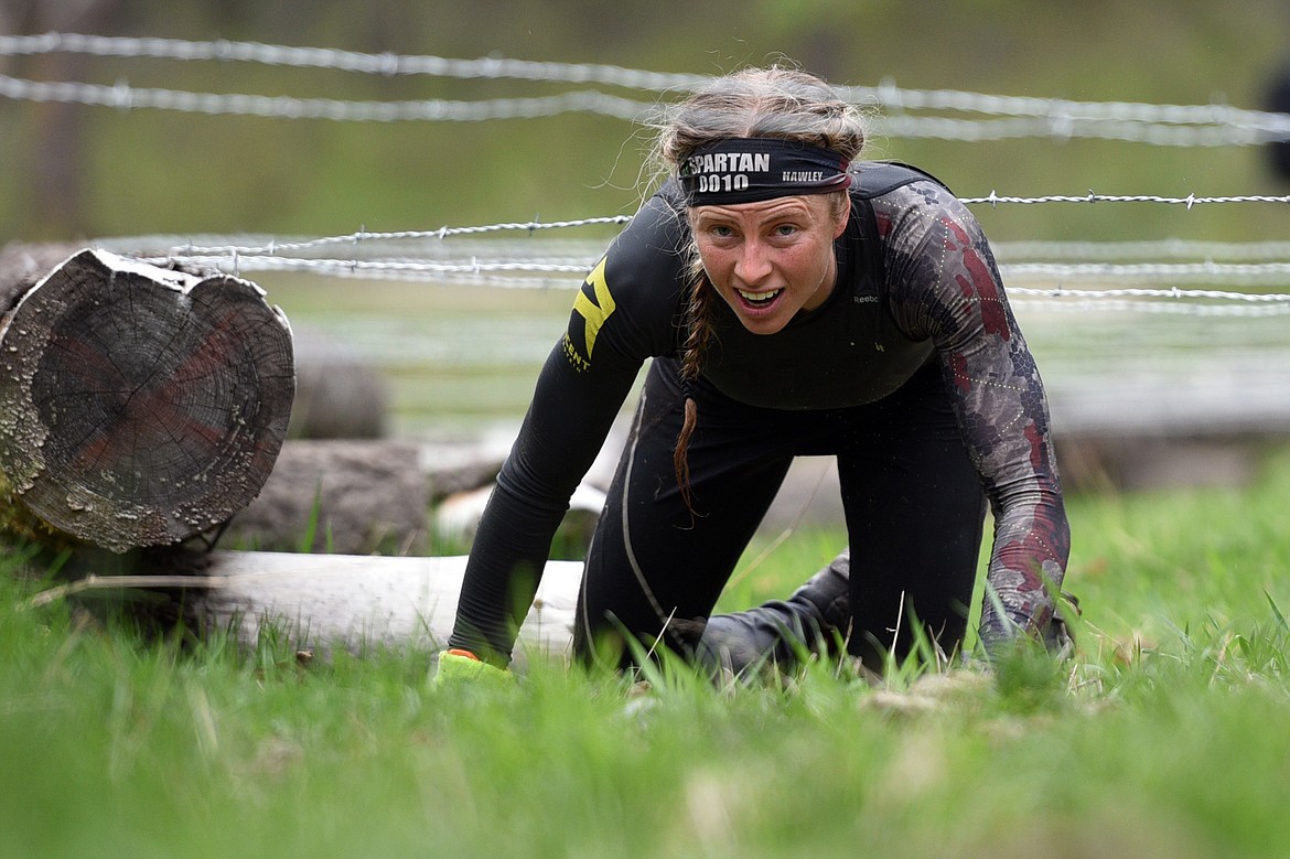 Competitors navigate a barbed wire section of the 13-mile &#147;Beast&#148; course at Spartan&#146;s Mountain Series Race in Bigfork on Saturday. (Casey Kreider/Daily Inter Lake)