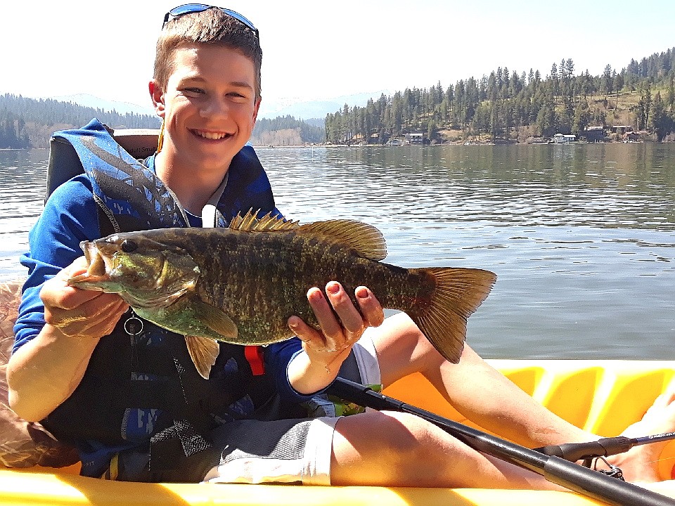 Courtesy photos
Evan Foil, 13, with one of the bass he caught this year on a crank bait in Lake Coeur d&#146;Alene where he and his brother, Ridley, fish the old-fashioned way, using kayaks and lake maps.