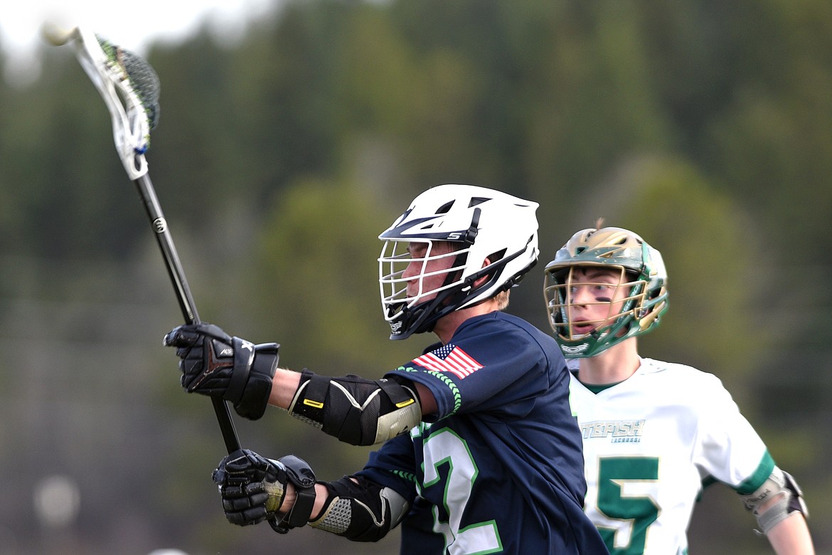 Glacier&#146;s Lincoln Jones (12) scores a first-half goal against Whitefish on Thursday. Whitefish&#146;s Riley Gulick (25) trails on defense. (Casey Kreider/Daily Inter Lake)