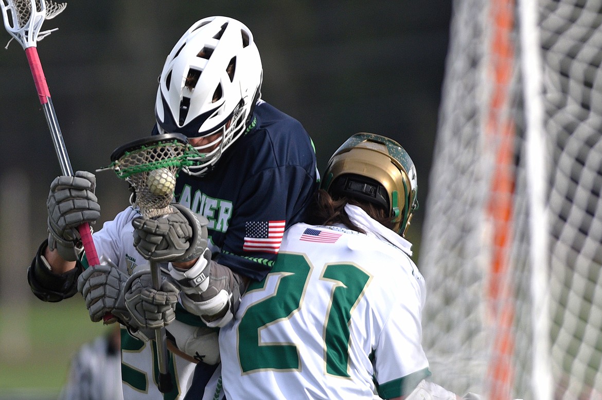 Glacier&#146;s Logan Hill (19) is sandwiched by Whitefish defenders Zach Cote (21) and Tristan Alexander (20) on Thursday. (Casey Kreider/Daily Inter Lake)