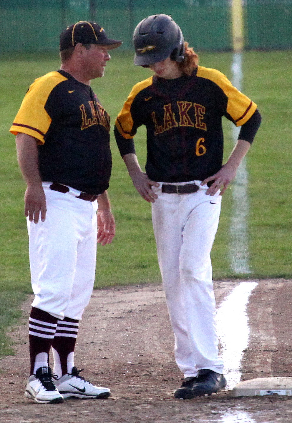 Rodney Harwood/Columbia Basin Herald
Moses Lake head coach Donnie Lindgren talks with baserunner Emmitt Tatum. Tatum has been playing for Lindgren since he was eight years old.