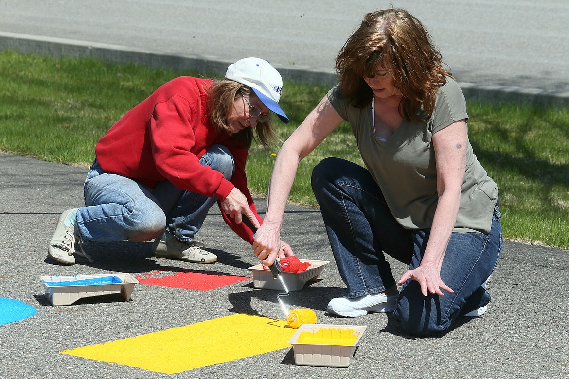 Vicki Campbell and Jeri Kilburg painted shapes on the Born Learning Trail, an early childhood education initiative of the Panhandle Kiwanis Club, United Way of North Idaho, Coeur d&#146;Alene High School Key Club, and city parks and recreation department. The trail formally opens this Saturday at 11 a.m. at Shadduck Lane Park. (JUDD WILSON/Press)