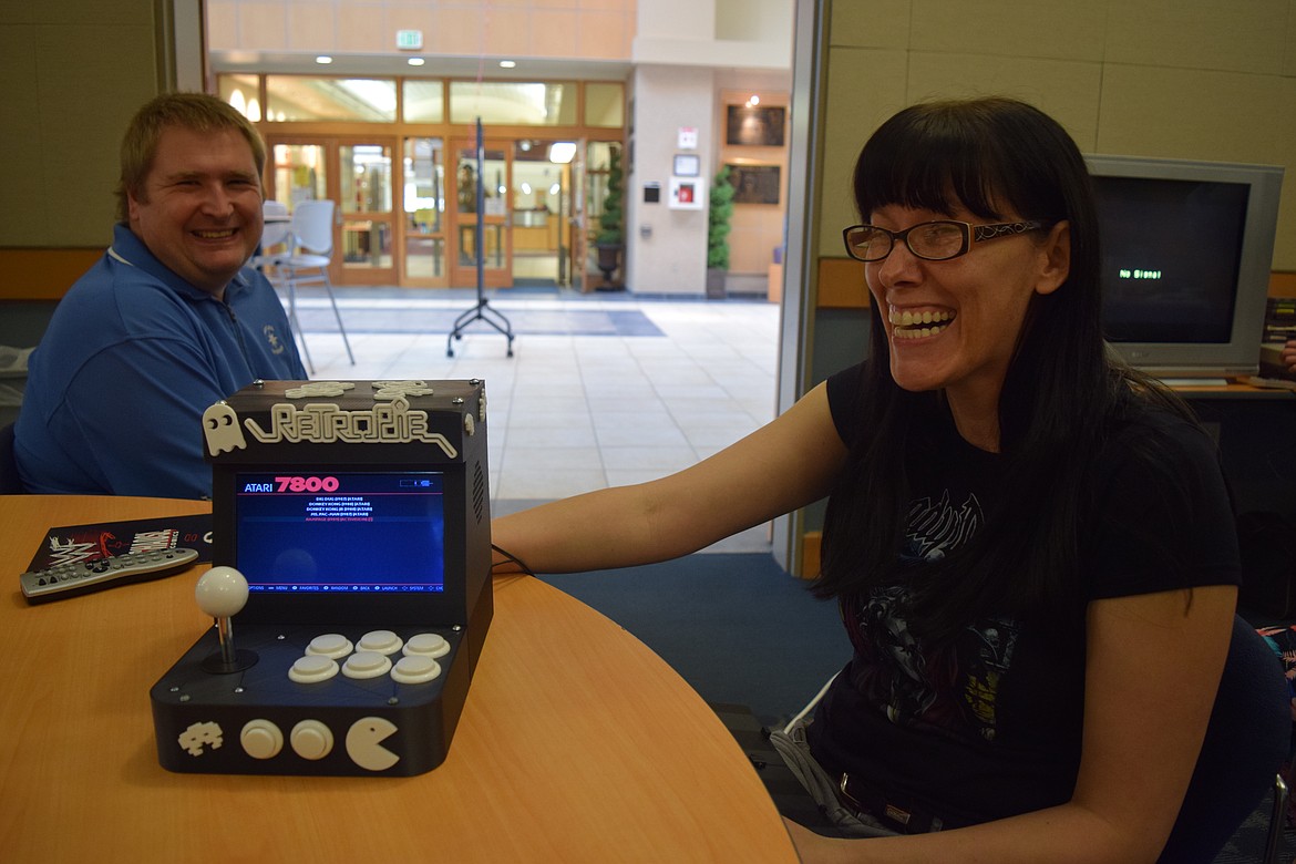 Charles H. Featherstone/Columbia Basin Herald
Stacey Dzbenski (right), with Andy Kroupa, shows off the RetroPi arcade simulator she made at Free Comic Book Day on the BBCC campus on Saturday.