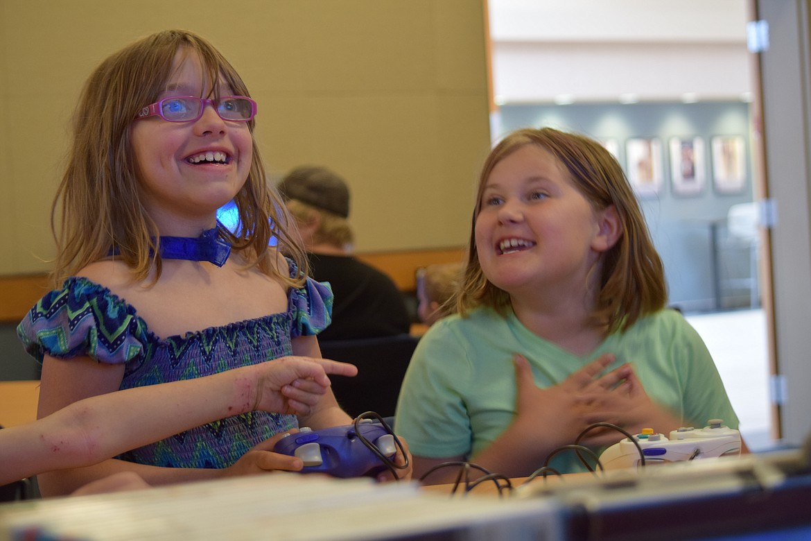 Charles H. Featherstone/Columbia Basin Herald
Gamers Mahayla Roberson (left) and Ella Neef finish a round of Mario Kart at BBCC on Saturday during Free Comic Book Day.