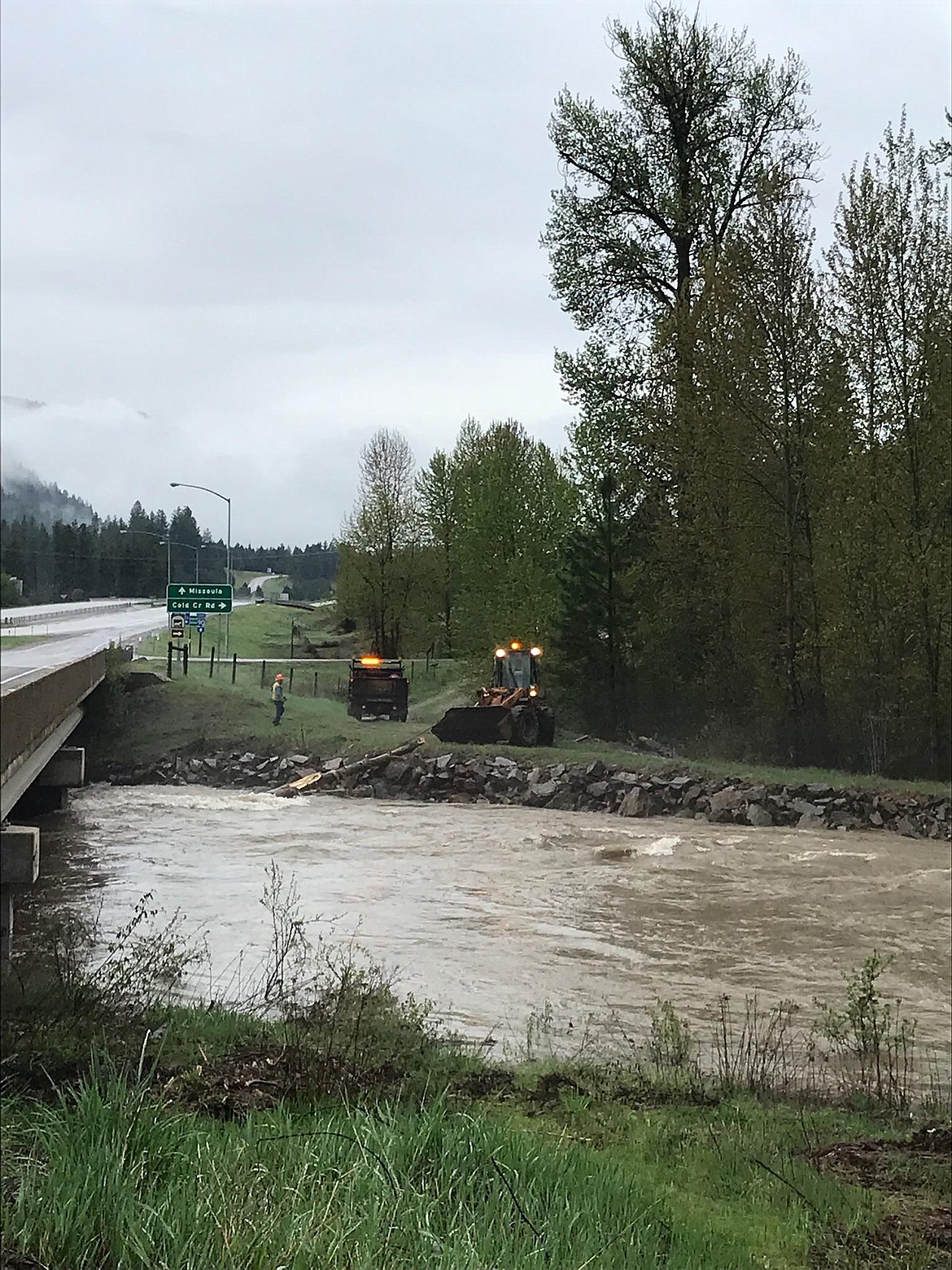 State work crews pull logs and other debris out of the Clark Fork River near St. Regis after a severe storm brought high winds, hail, and rain on Sunday evening. Blowing down large trees, signs, and&#160; causing other minor damage in the area. (Photo by Caron Fenn)