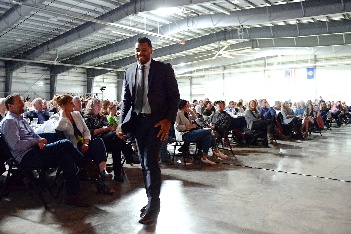 Seattle Seahawks quarterback Russell Wilson walks to the stage to speak at an event held by Stillwater Christian School at the Flathead County Fairgrounds in Kalispell on Wednesday. (Casey Kreider/Daily Inter Lake)