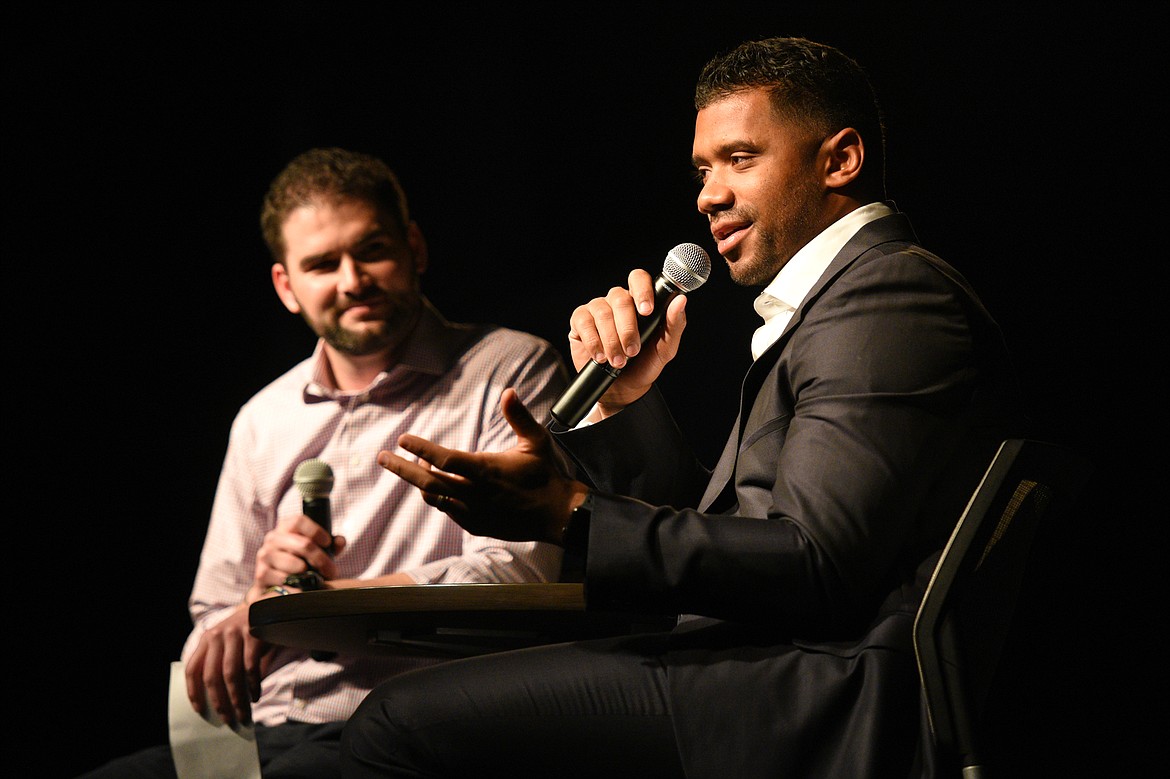 Seattle Seahawks quarterback Russell Wilson is interviewed by Darnay Tripp at an event held by Stillwater Christian School at the Flathead County Fairgrounds in Kalispell on Wednesday. Tripp is sports director at KREM 2 in Spokane, Washington. (Casey Kreider/Daily Inter Lake)