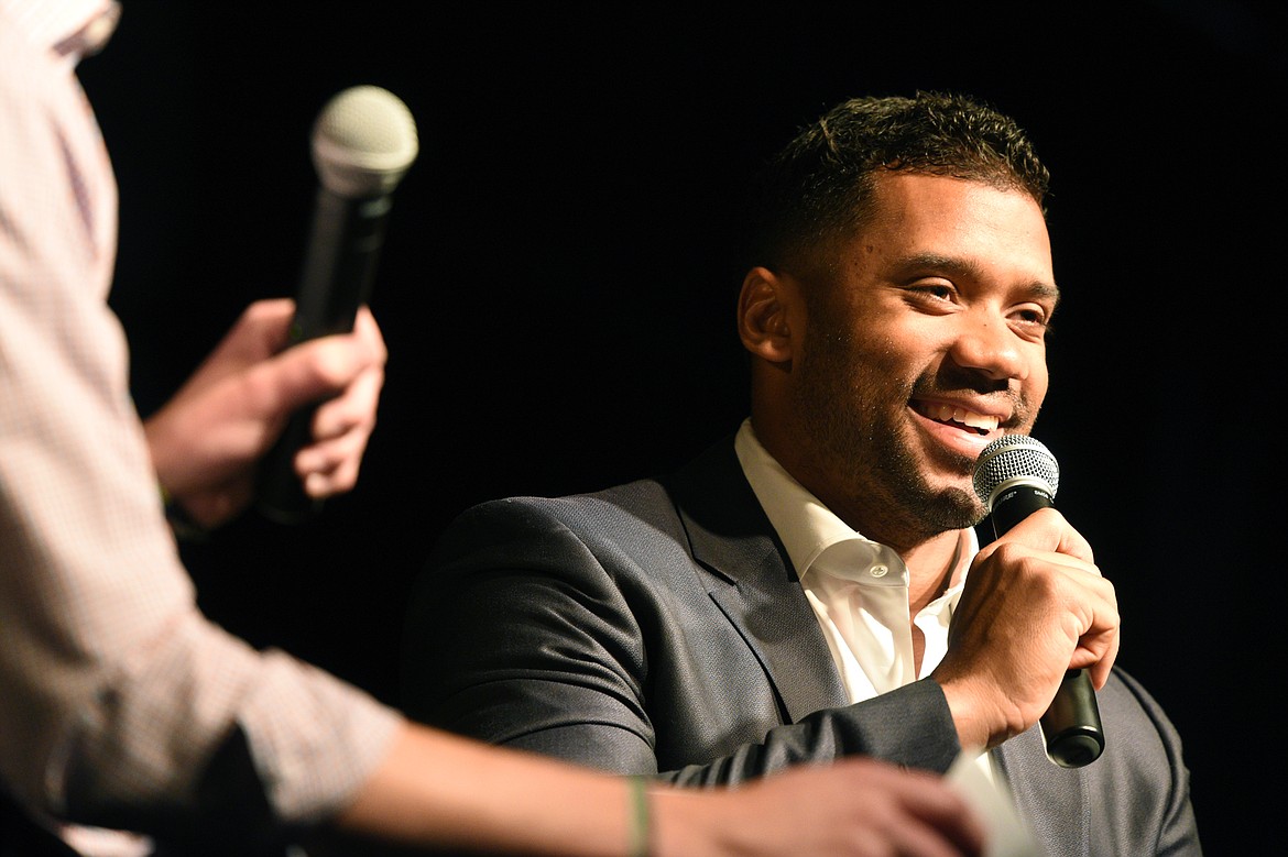 Seattle Seahawks quarterback Russell Wilson is interviewed by Darnay Tripp at an event held by Stillwater Christian School at the Flathead County Fairgrounds in Kalispell on Wednesday. Tripp is sports director at KREM 2 in Spokane, Washington. (Casey Kreider/Daily Inter Lake)