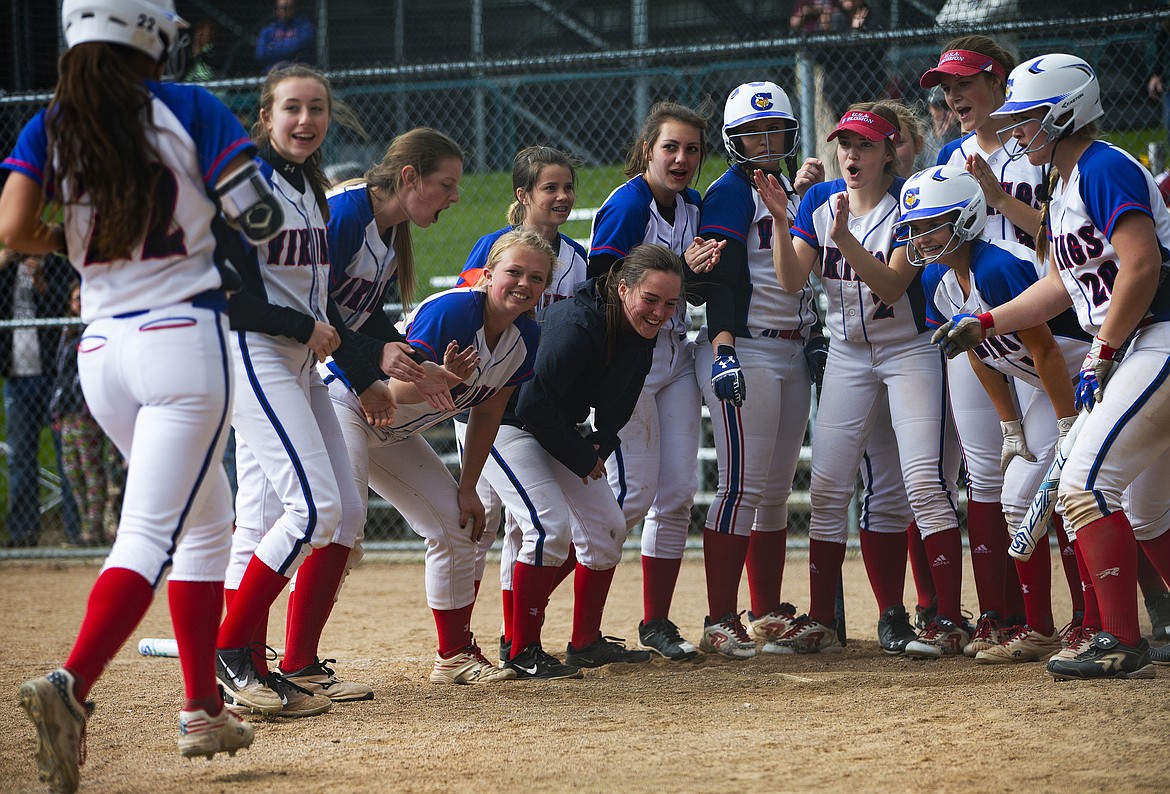 Teammates greet Kaylin Donovan at home plate after she hit a home run against Lake City in Tuesday&#146;s game. (LOREN BENOIT/Press)