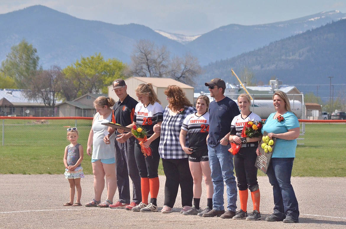 Trotter Seniors Jessica Thompson (Plains) and Stacey Grey (Hot Springs) are presented on the pitchers mound to the crowd by their families at the double-header against Troy on Friday. (Erin Jusseaume/ Clark Fork Valley Press)