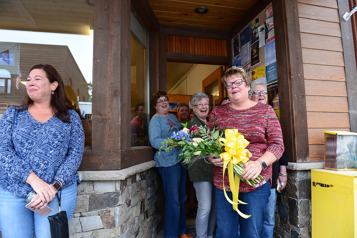 Donna Lawrence, right, is surprised with a parade outside The Jug Tree in downtown Bigfork on Saturday. (Casey Kreider/Daily Inter Lake)