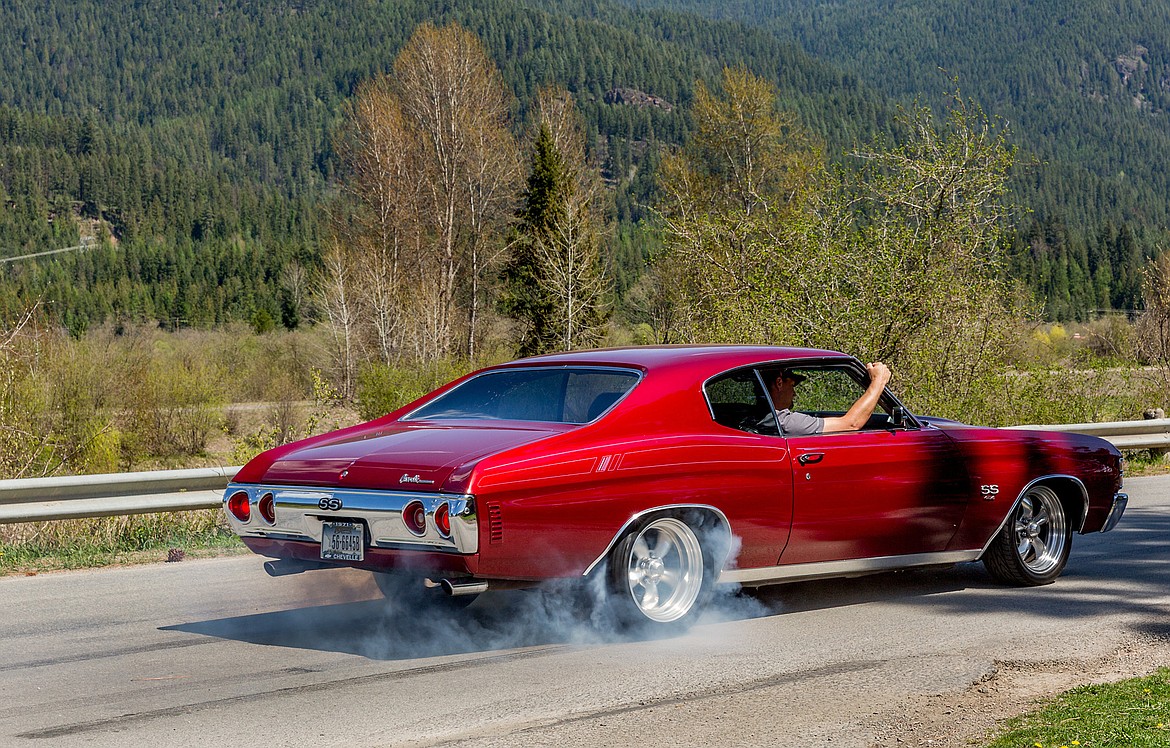Nik Rewerts rides shotgun as his dad, retiring Noxon High School Principal Rik Rewerts, burns out in his 1971 Chevrolet Chevelle SS 454 Friday in Noxon. (John Blodgett/The Western News)