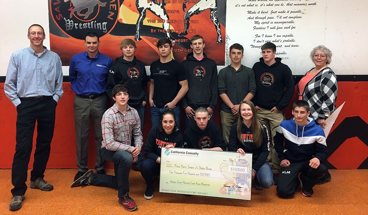 Members of the Savage Horsemen team presented with their $1,500.00 grant cheque along with Plains High School Principal Kevin Meredith (far left) and Debbie Brown (far right) (photo supplied)