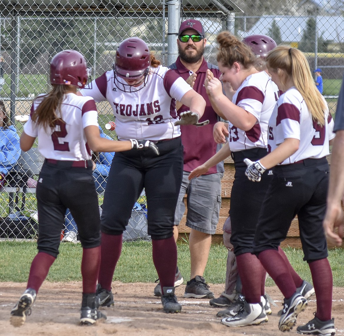 Troy sophomore Montana Rice keeps the plate clear for freshman Talise Becquart as she completes her first ever home run during Troy’s 23-20 loss to Bonners Ferry Thursday.