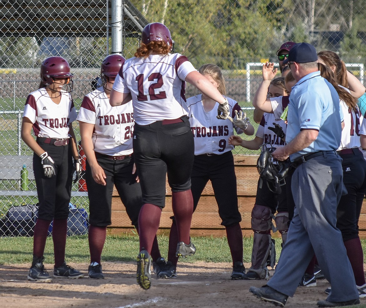 Troy sophomore Montana Rice adds a little bounce to her step as she is received by her teammates after hitting a home run during Troy&#146;s 23-30 loss to Bonners Ferry Thursday. (Benjamin Kibbey/The Western News)
