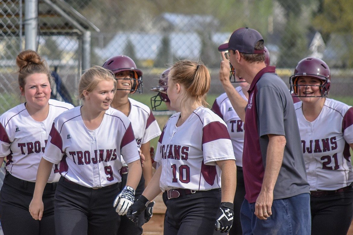 Head Coach Keith Haggerty reaches in to high-five freshman Talise Becquart as she is surrounded by teammates congratulating Becquart on her first ever home run during Troy&#146;s 23-20 loss to Bonners Ferry Thursday.