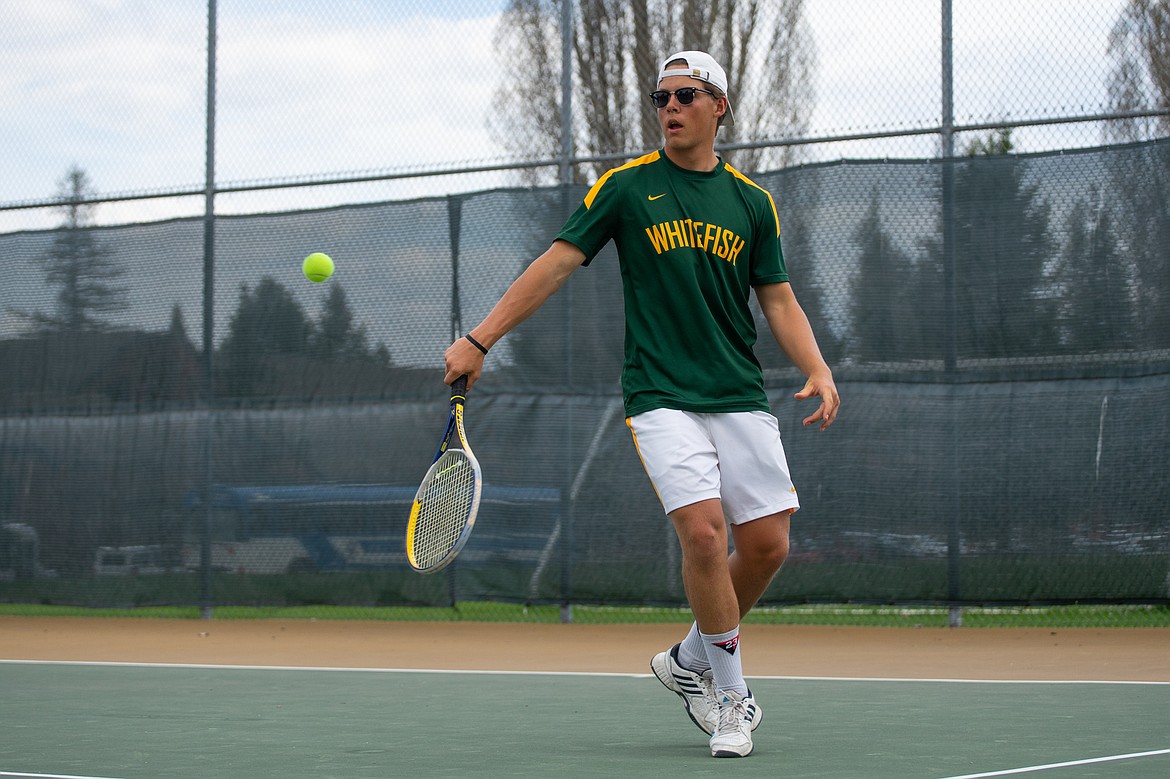 Forrest Kobelt casually returns a Columbia Falls serve during a doubles match last Thursday at Grouse Mountain Lodge.