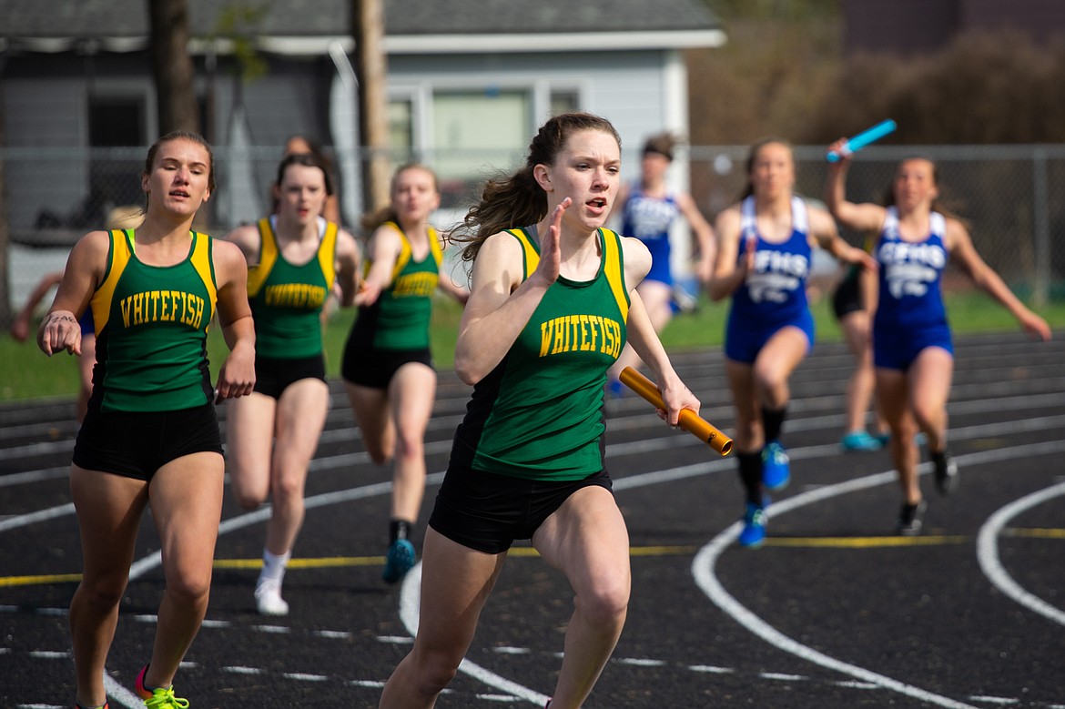 Lauren Schulz races ahead in the last leg of the 4x100 relay at the Ken Good Dog-Cat Invite last Tuesday at Whitefish. (Daniel McKay photos/Whitefish Pilot)