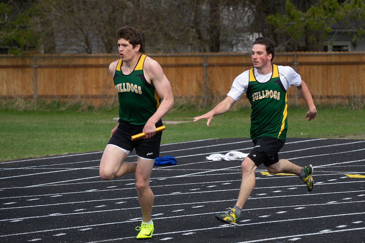 Dillon Botner takes the baton in the 4x100 relay at the Ken Good Dog-Cat Invite last Tuesday at Whitefish.