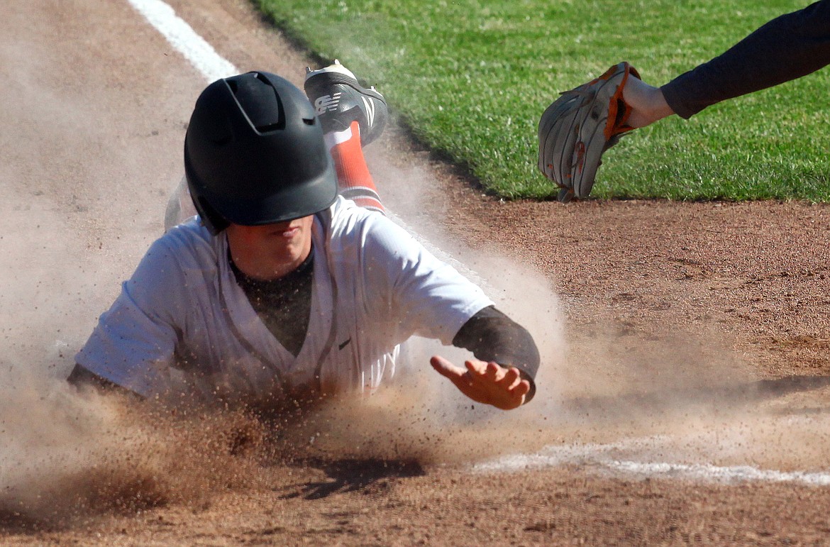 Rodney Harwood/Columbia Basin Herald
Ephrata runner Seth Elliott beats the come-back throw to the plate on a wild pitch to score in the first inning of Tuesday's CWAC District Tournament at Johnson-O'Brien Stadium.