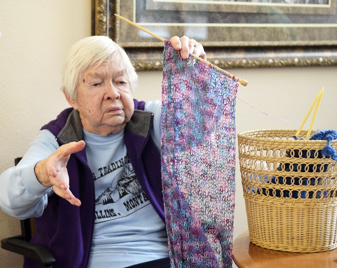 Millie Tarter shows of a scarf she is making during a gathering of the Knit Wits group at The Springs at Whitefish. (Heidi Desch/Whitefish Pilot)