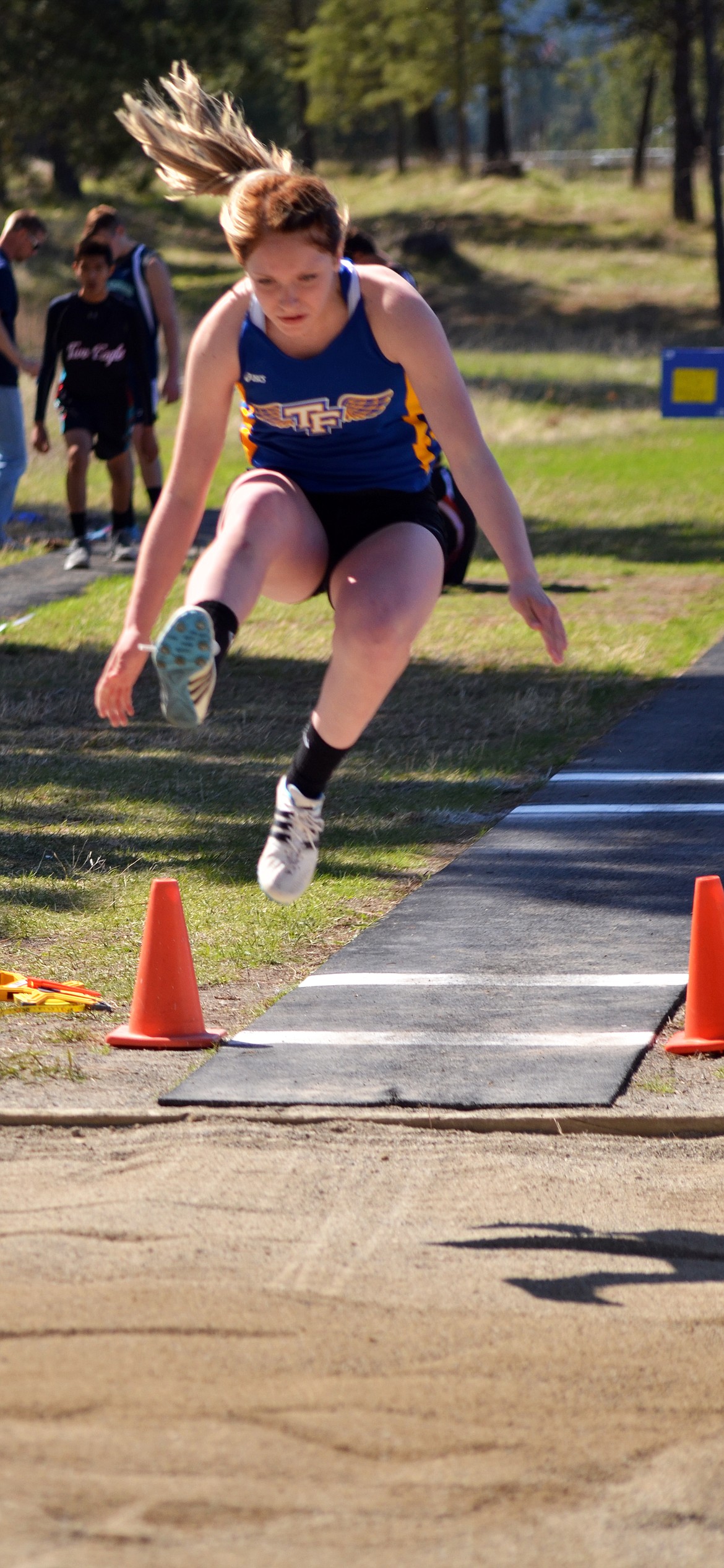 Bluehawk Riley Wilson takes off in the long jump. (Erin Jusseaume/ Clark Fork Valley Press)