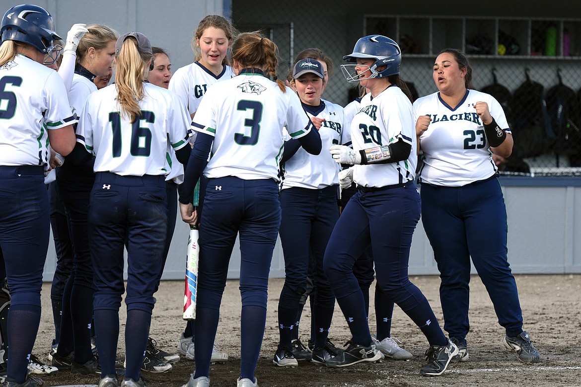 Glacier's Allee Meyer is congratulated by teammates after a two-run home run in the bottom of the third against Polson. (Casey Kreider/Daily Inter Lake)