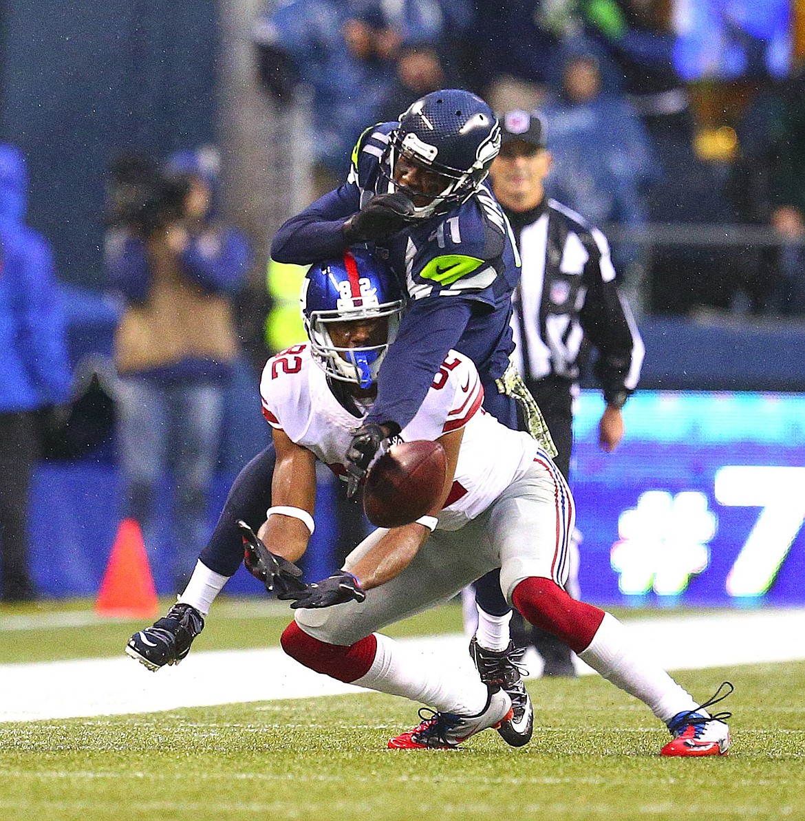 Seattle Seahawks cornerback Byron Maxwell, top, breaks up a pass intended for New York Giants wide receiver Reuben Randle in the second half on Sunday, Nov. 9, 2014, at CenturyLink Field in Seattle. The Seahawks won 38-17. (John Lok/Seattle Times/MCT)