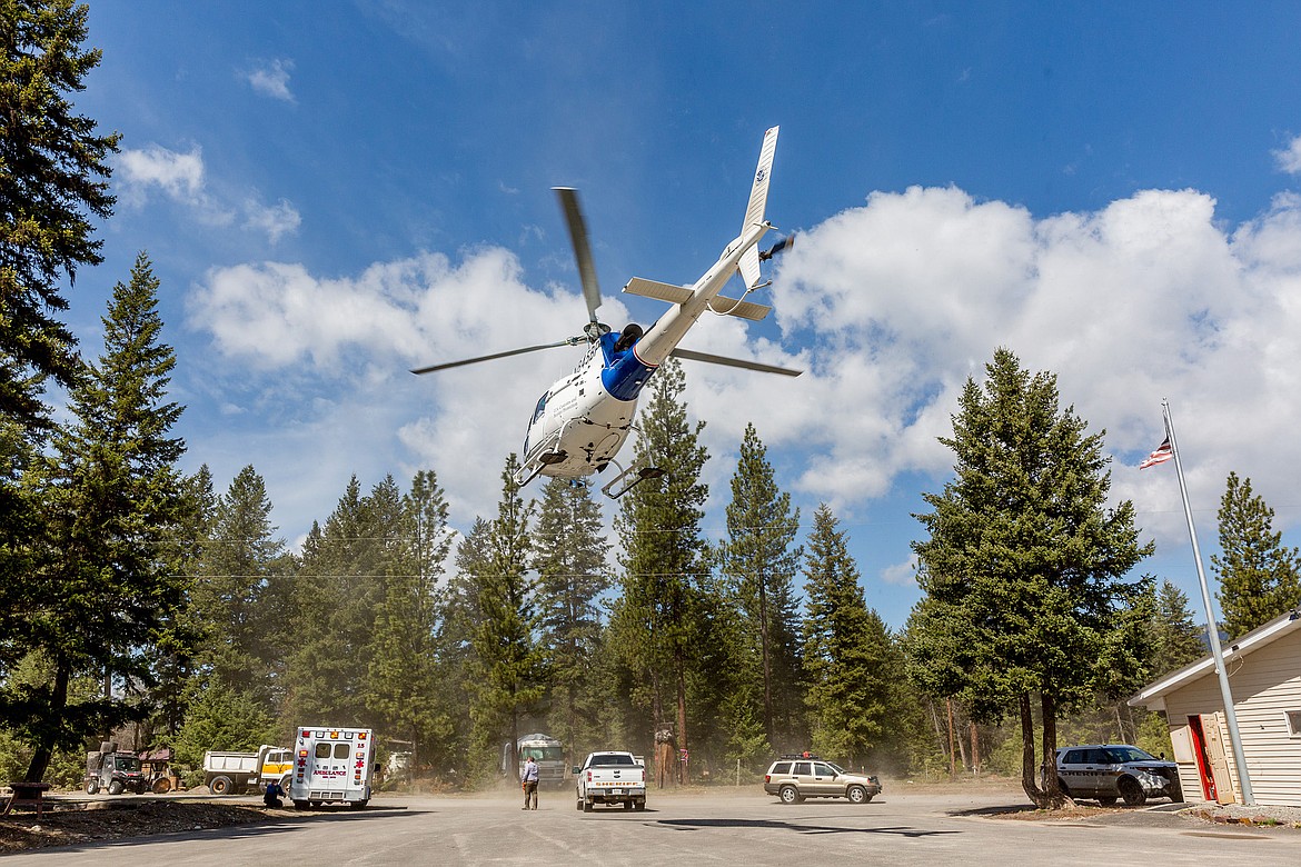 A Border Patrol helicopter from Spokane lands at the command center set up at Fisher River Fire Station No. 1 on Wednesday, May 2, 2018. (John Blodgett/The Western News)