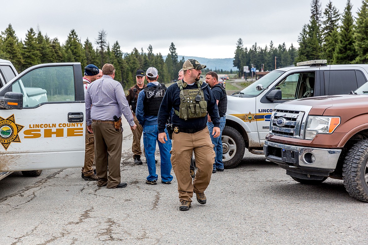 Lincoln County Sheriff&#146;s Office personnel assemble where Crystal Lake Road meets Highway 2 in Happys Inn on Wednesday. (John Blodgett photos/The Western News)