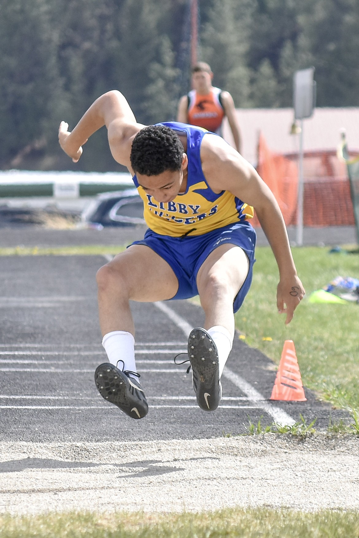 Libby junior Eli Smith competes in the long jump at the Lincoln County Track Meet Tuesday. (Benjamin Kibbey/The Western News)