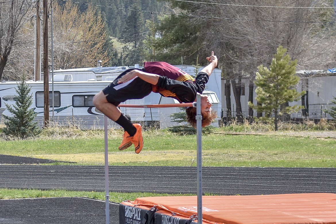 Troy sophomore Ricki Fisher lays glides over the bar at a personal record 5 feet 4 inches during the Lincoln County Track Meet Tuesday. (Benjamin Kibbey/The Western News)