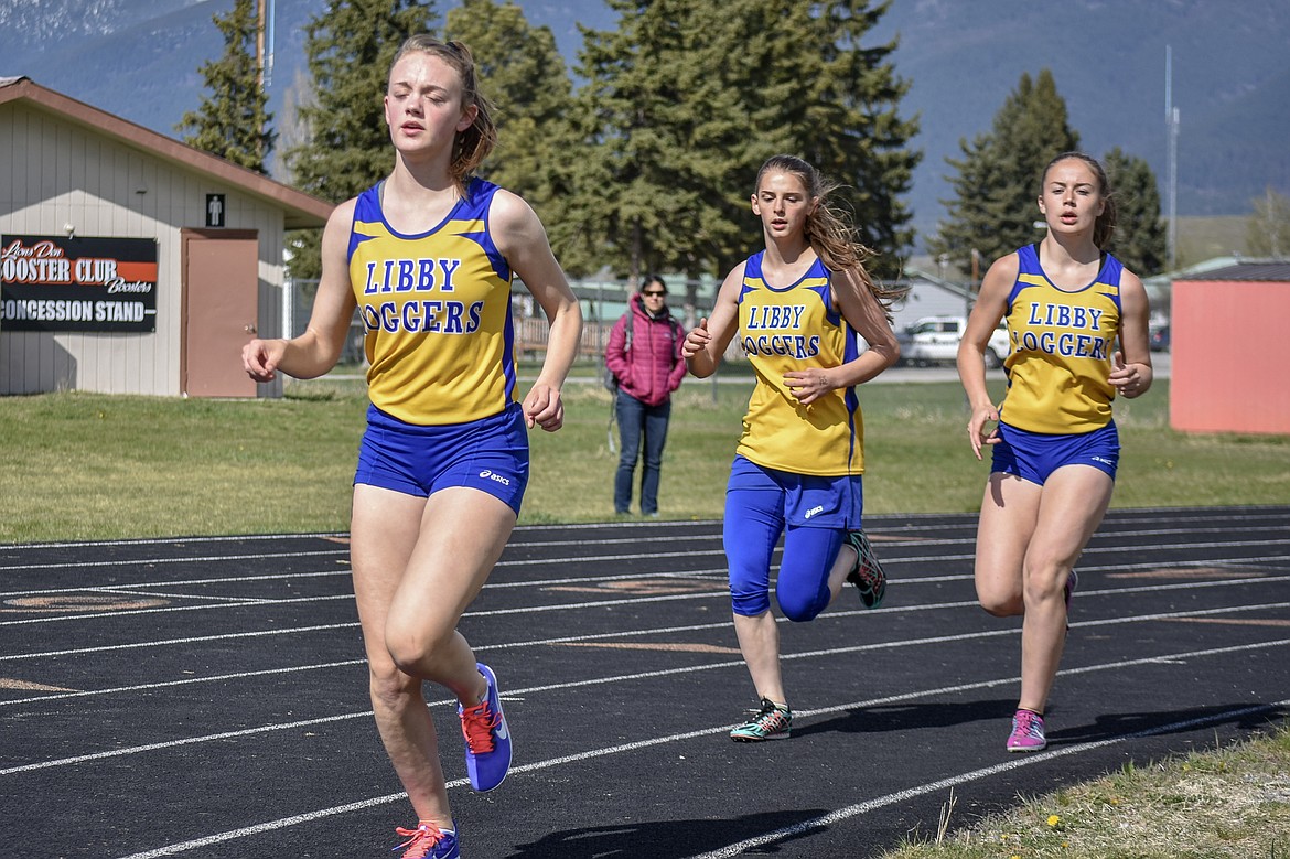 Libby junior Lauren Thorstenson, freshman Halona LaFleur and sophomore Kylee Quinn compete in the 1,600m run at the Lincoln County Track Meet Tuesday. The trio finished first, third and second, respectively. (Benjamin Kibbey/The Western News)