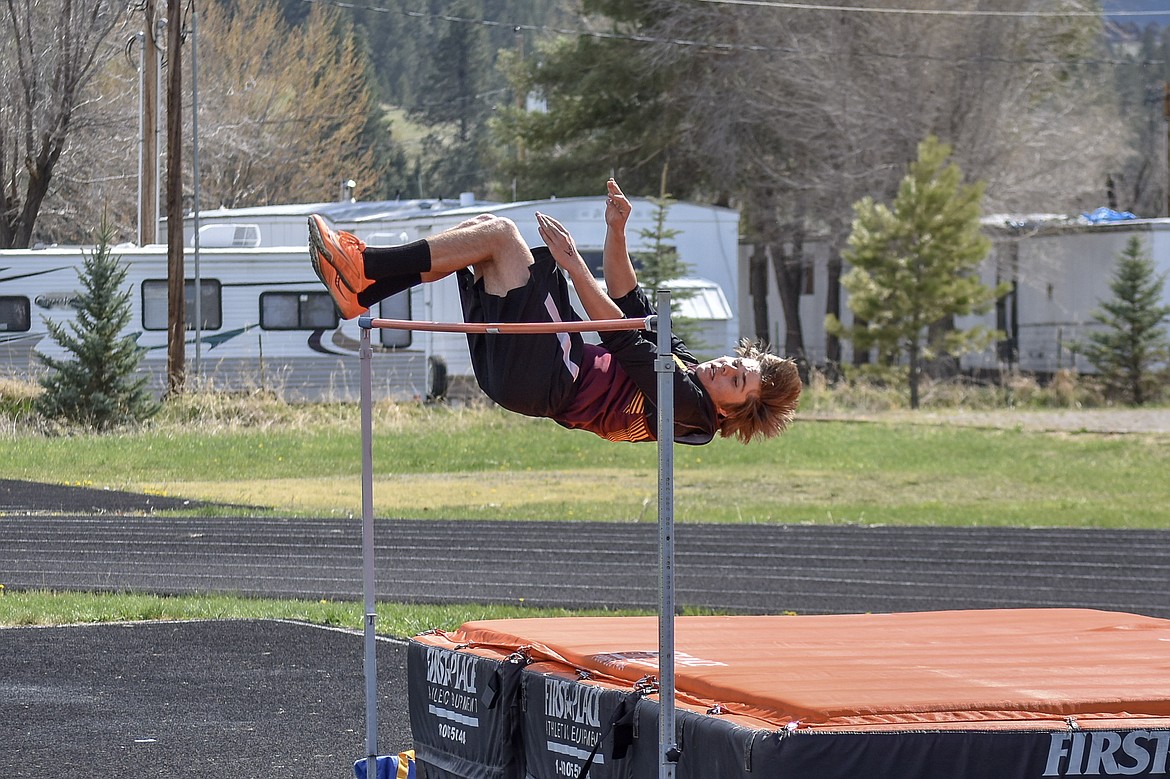 Troy sophomore Ricki Fisher eyes the bar as he clears it at a personal record 5 feet 4 inches during the Lincoln County Track Meet Tuesday. (Benjamin Kibbey/The Western News)