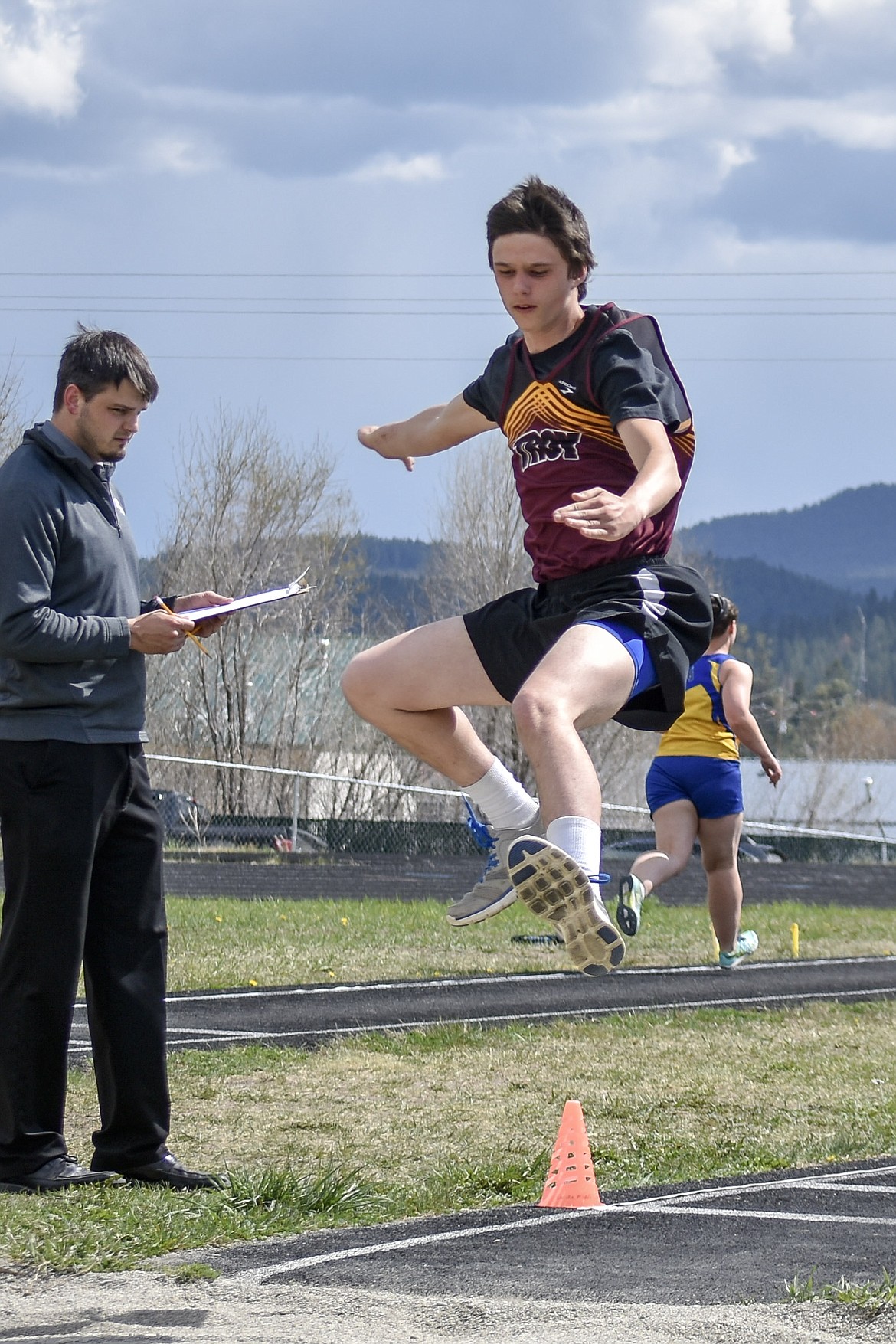 Troy sophomore Brodie Gravier competes in the long jump at the Lincoln County Track Meet Tuesday. (Benjamin Kibbey/The Western News)